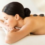 Female Client lying on Stomach with Hot Stone placed on back